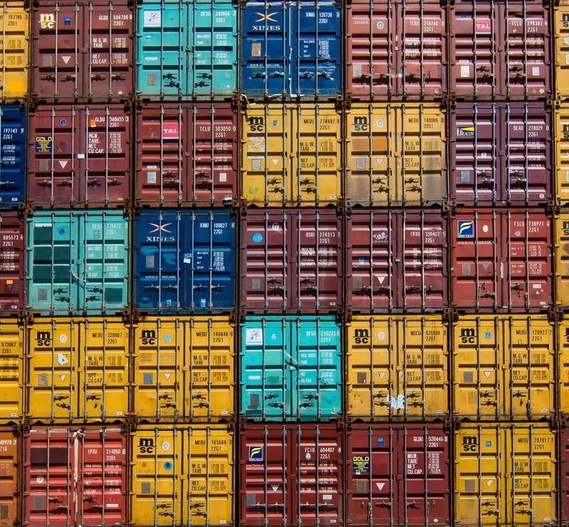 Shipping containers stacked in rows at a container terminal