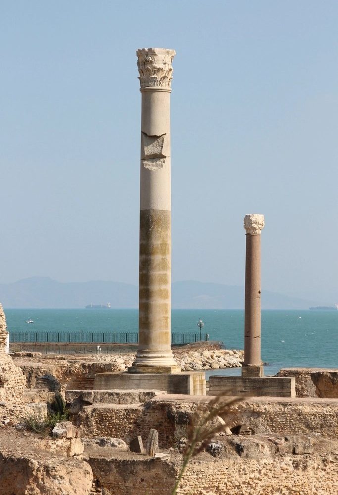 Two ancient stone columns standing by the Mediterranean sea at Carthage, Tunisia